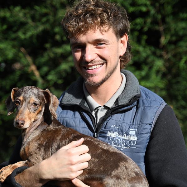 Adam holding Daphne, one of our resident Miniature Dachshunds, in the garden